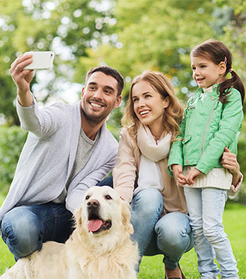 Family together outdoors with a phone
